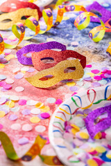 Party and carnival concept with masks, confetti and streamers