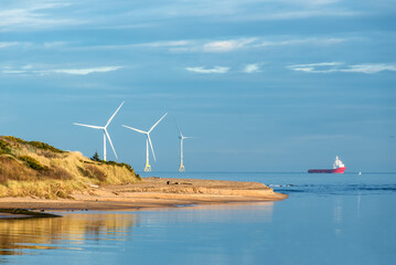 Offshore wind turbine farm, offshore supply vessel and Don River Delta on Scotland coast of Aberdeen, UK © Val Traveller