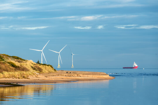 Offshore wind turbine farm, offshore supply vessel and Don River Delta on Scotland coast of Aberdeen, UK