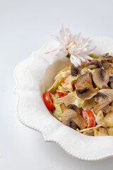 Close-up of mushroom salad with tomatoes, appetizing vegetable dish