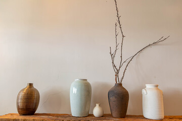 Different ceramic vases on wooden background, The Pottery Gallery.	