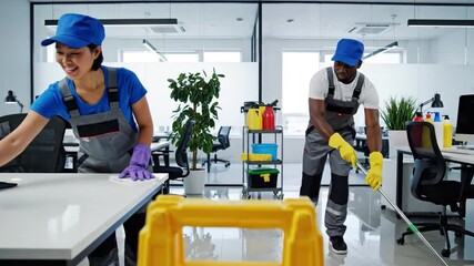 Professional Cleaners at Work: A pair of dedicated cleaners, equipped with supplies, bring order and hygiene to a modern workspace. Capturing the essence of cleanliness and professional service.