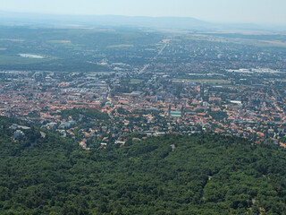 Obraz premium Fourteenth image in a series featuring a panoramic view of the city of Pécs, Hungary, captured from the observation deck of the TV tower. Elevated viewpoint highlighting the urban landscape, rooftops,