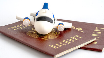A toy plane on a foreign passport. vacation and new year holidays concept