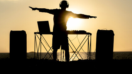 DJ on the beach during sunset