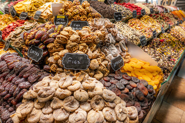 Large display of various dried fruits including figs dates and apricots at a bazaar stall