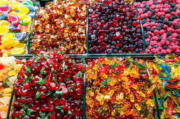 Assortment of colorful gummy candies in various shapes and flavors at a market stall