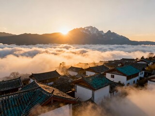 Traditional village rooftops emerging from sea of clouds at sunrise with snow-capped mountain in background