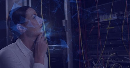 Network engineer raising hand to chin, engaging holographic overlay while monitoring cables - Powered by Adobe