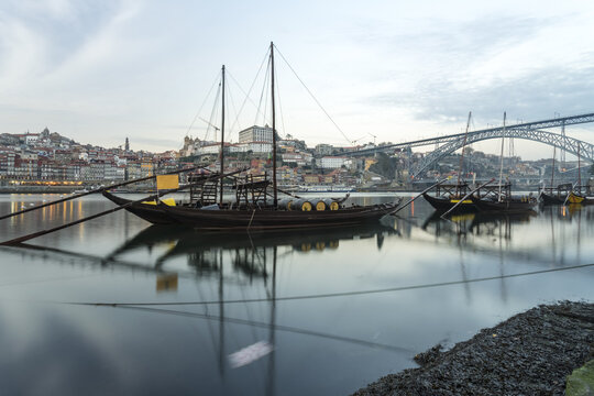 View of boats floating on the water with the Dom Lu&Atilde;&shy;s I Bridge in the background under a cloudy sky, Porto, Porto District, Portugal.