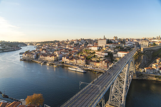View of the Dom Lu&Atilde;&shy;s I Bridge stretches over the Douro River with the city's terracotta rooftops under a serene sky, Porto, Porto District, Portugal.