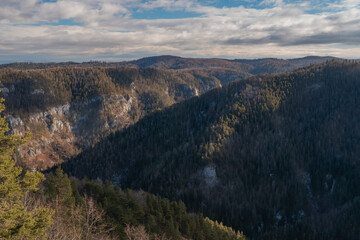 View of a majestic landscape with rugged peaks, lush forests, and sun dappled slopes creating a picturesque scene, Slovensky Raj, Kosice Region, Slovakia.