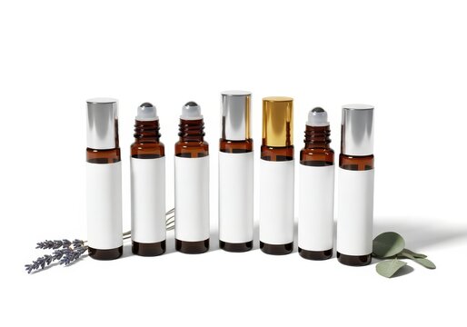 Row of amber glass essential oil roller bottles with blank labels sits against a white background