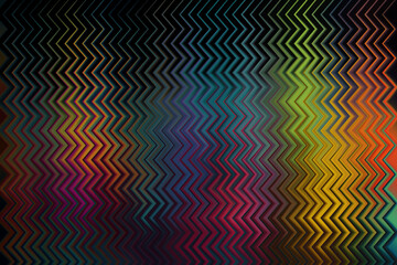 Multi-colored rainbow zigzag pattern on a dark background with a high contrast geometric look