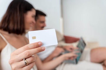 Couple engaging in online shopping and convenient e-commerce using a secure credit card from their home, making digital payments and enjoying modern banking services