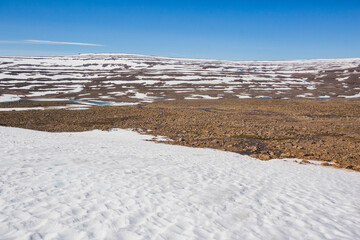 Rocks and snow on the Putorana Plateau. Taimyr. Russia