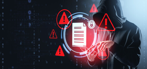 Hacker in hoodie accessing digital document with warning symbols