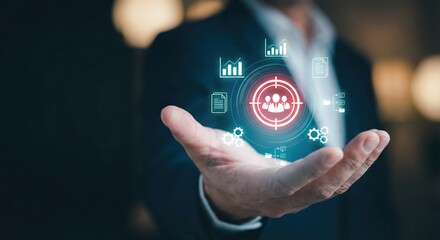 Close up of an adult man in a suit holding a glowing digital target icon for customer segmentation and audience targeting concept in a dark office, professional business marketing.