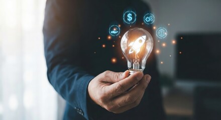Successful South Asian adult businessman holding a glowing light bulb with a rocket icon and digital icons in a dark indoor studio, startup launch and business innovation concept, wearing a blazer
