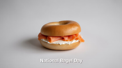 A bagel sandwich with cream cheese and smoked salmon on a plain background, celebrating National Bagel Day