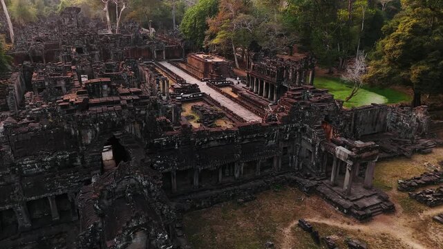 Aerial view of the ancient stone ruins of a historic temple of angkor thom, surrounded by the lush green jungle in siem reap, Cambodia. Unesco heritage site.