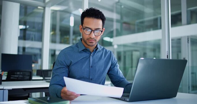 Laptop, typing or businessman with paper in office, statement audit or check accounting compliance. Reading, document accuracy or employee review finance report, record finding or edit mistake on pc