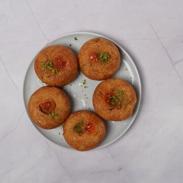 Balushahi is a classic Indian sweet dessert made from refined flour dough, deep-fried until crisp on the outside and soft inside, then soaked in light sugar syrup. Known for its flaky layers, rich ghe