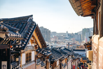 Bukchon Hanok Village traditional houses with modern Seoul city skyline 