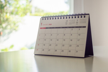 desk calendar showing January 2026 page on white table background for business organization