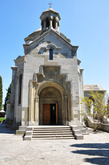 Ancient stone church built in traditional Armenian architectural style with arched doorway and carvings. Located in a southern city, perfect for travel, architecture, and history themes.
