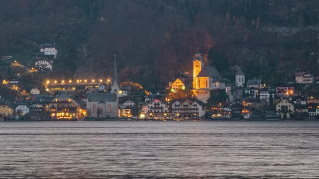 Day to night transition time lapse Hallstatt village over Hallstatter See in Salzkammergut, Upper Austria.