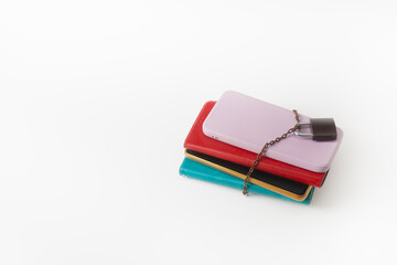 Several smartphones, chained and locked, on a white background. Digital overload and fatigue. Gadget addiction.