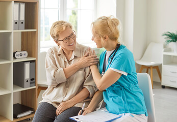 Support and care touch of doctor to happy senior woman, smiling nurse touching patients shoulder...