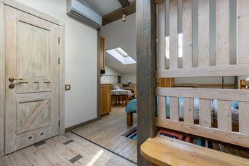 Entrance view to rustic attic studio with wooden door