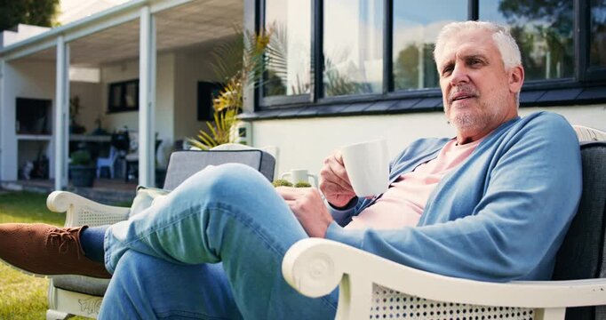 Thinking, coffee and senior man in backyard, relax and retirement with afternoon break. Outdoor, house and mature person with ideas, memory and herbal tea with moment, pensioner and nursing facility