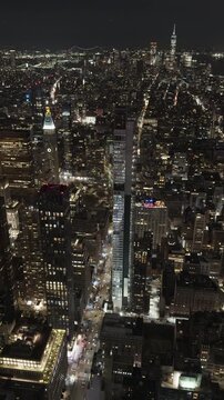 New York City skyline at night with traffic below vertical format