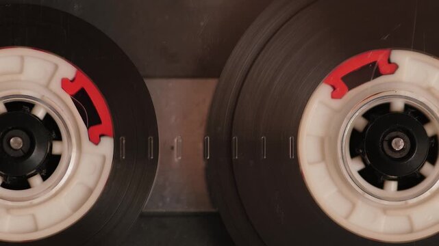 Macro close-up vintage audiocassette playing music spinning in cassette player