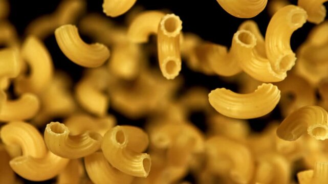 Super slow motion flying dry macaroni pasta . Filmed on a high-speed camera at 1000 fps. High quality FullHD footage