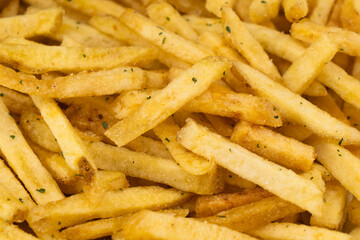 Potato chips fried in oil. French fries. Close up of hot french fries