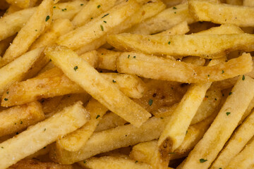 Potato chips fried in oil. French fries. Close up of hot french fries