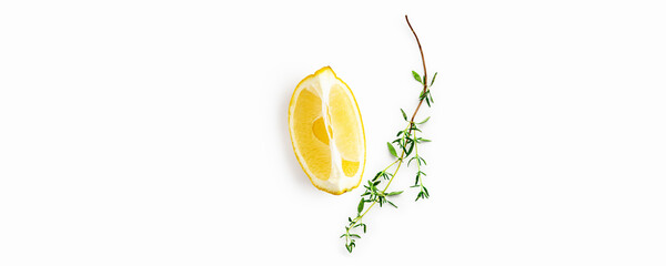 Lemon slice and fresh thyme isolated on white background. Minimalist natural composition