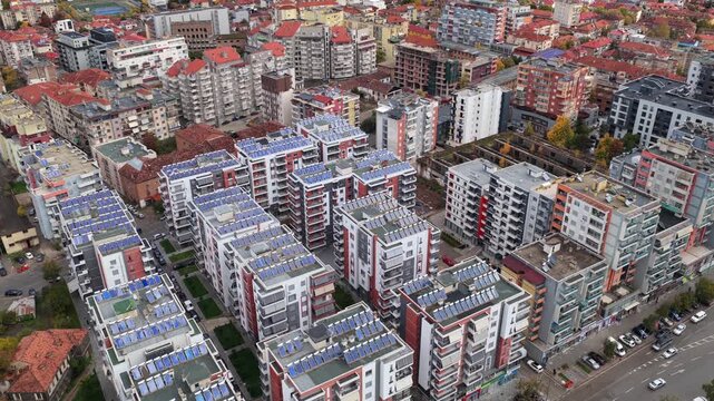 Aerial video of Kor&ccedil;&euml;&rsquo;s modern residential blocks featuring solar-paneled rooftops, balconies and dense urban architecture.
