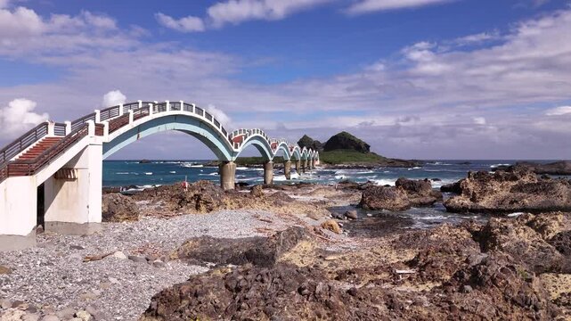 B roll of the Sanxiantai eight arch bridge in Taitung featuring a dragon shaped pedestrian bridge linking Taiwan and Sanxiantai Island with dramatic volcanic coastal landscapes