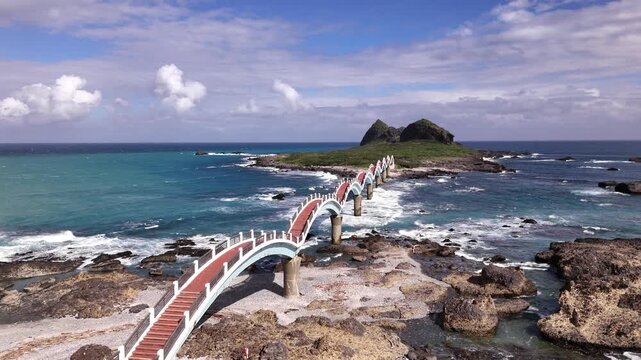 B roll of the Sanxiantai eight arch bridge in Taitung featuring a dragon shaped pedestrian bridge linking Taiwan and Sanxiantai Island with dramatic volcanic coastal landscapes