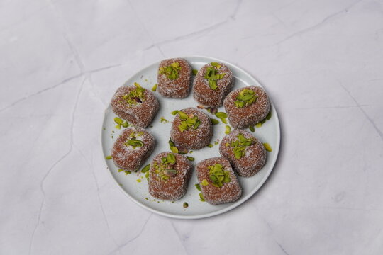 Kandi Pedha is a traditional Indian sweet made using fresh sugarcane juice (kandi), slowly reduced and cooked to achieve a rich, caramelized flavor. Known for its natural sweetness, soft texture, and 
