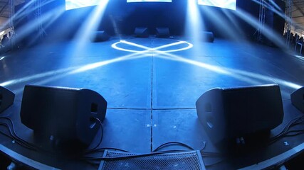 Dramatic stage lighting design with bright blue beams creating an artistic and abstract display