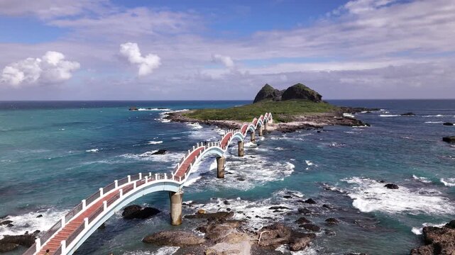 B roll of the Sanxiantai eight arch bridge in Taitung featuring a dragon shaped pedestrian bridge linking Taiwan and Sanxiantai Island with dramatic volcanic coastal landscapes