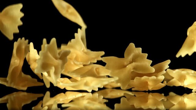 Super slow motion dry farfalle pasta . Filmed on a high-speed camera at 1000 fps. High quality FullHD footage