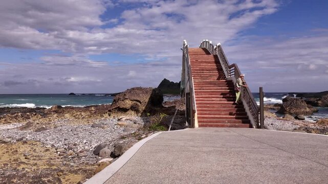 B roll of the Sanxiantai eight arch bridge in Taitung featuring a dragon shaped pedestrian bridge linking Taiwan and Sanxiantai Island with dramatic volcanic coastal landscapes