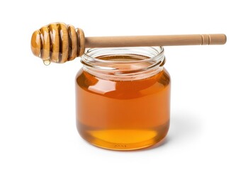 Glass jar filled with golden amber liquid sweetener rests upon a white background with a wooden dipper poised above.